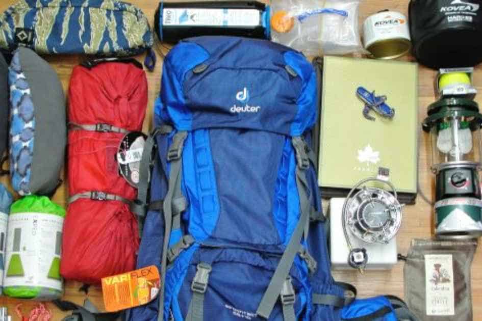 Essential camping gear for beginners, including a backpack, sleeping bags, and cooking equipment.