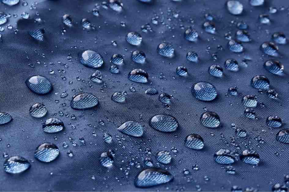 Close-up of water droplets beading up on waterproof tent fabric, demonstrating the effectiveness of weatherproofing.