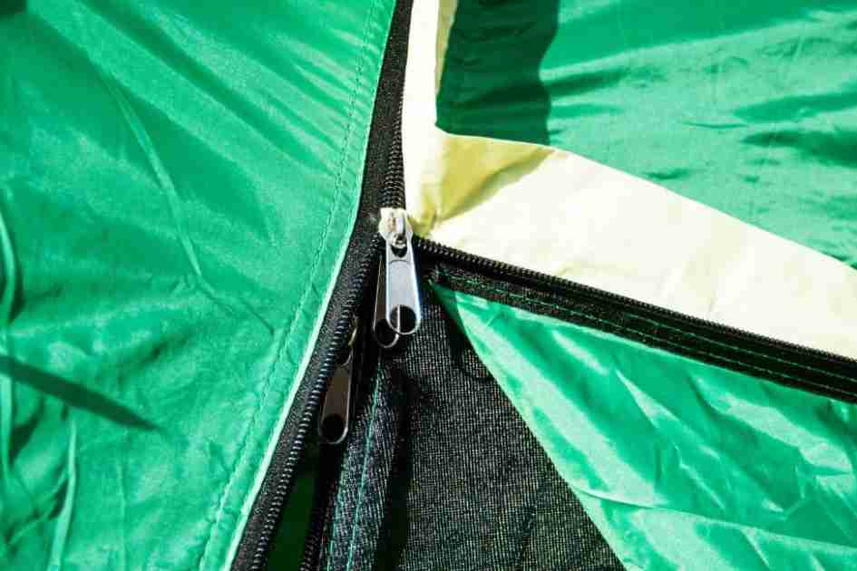 Close-up of tent seams and zipper, illustrating critical points for weatherproofing a tent.